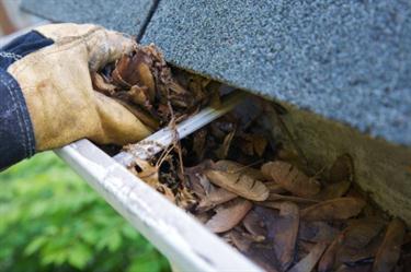 Cleaning gutter in Southside Place, TX.